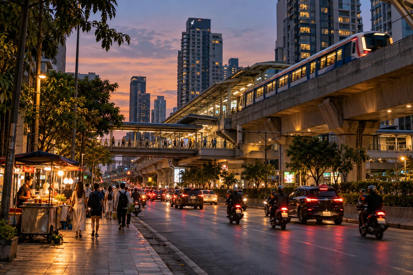 The elevated BTS track above Sukhumvit Road near Ekkamai in the early evening, with people walking along the pavement below and condominium towers behind